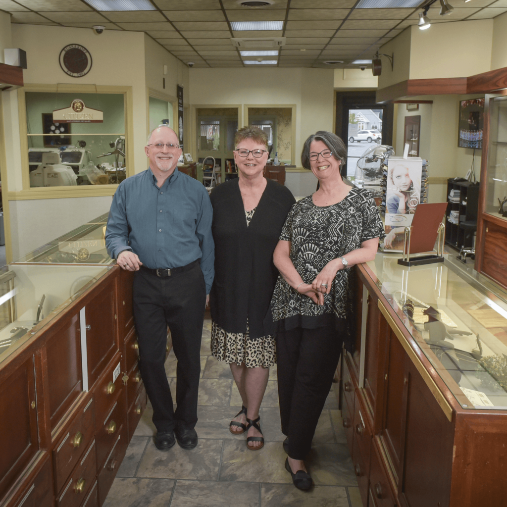 Andrew and Donna Russakoff standing with another person inside the jewelry store